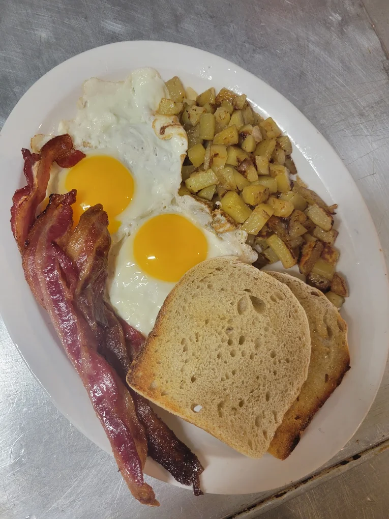 Breakfast plate with eggs, bacon, hash browns and sourdough toast in Lead, SD