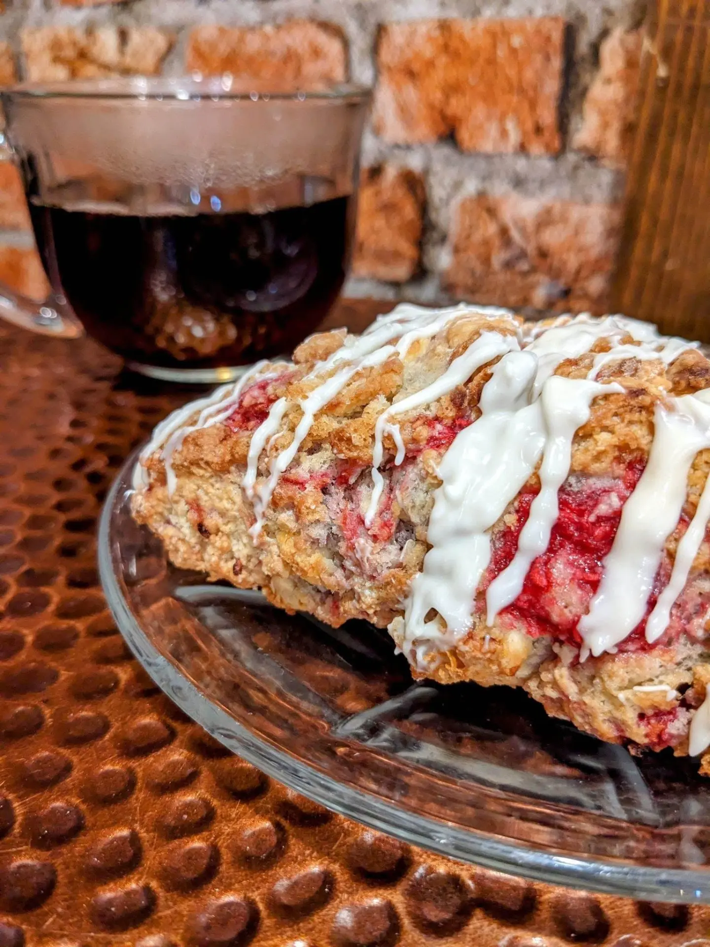 Flaky iced scone with a cup of coffee at a bakery in Lead, SD